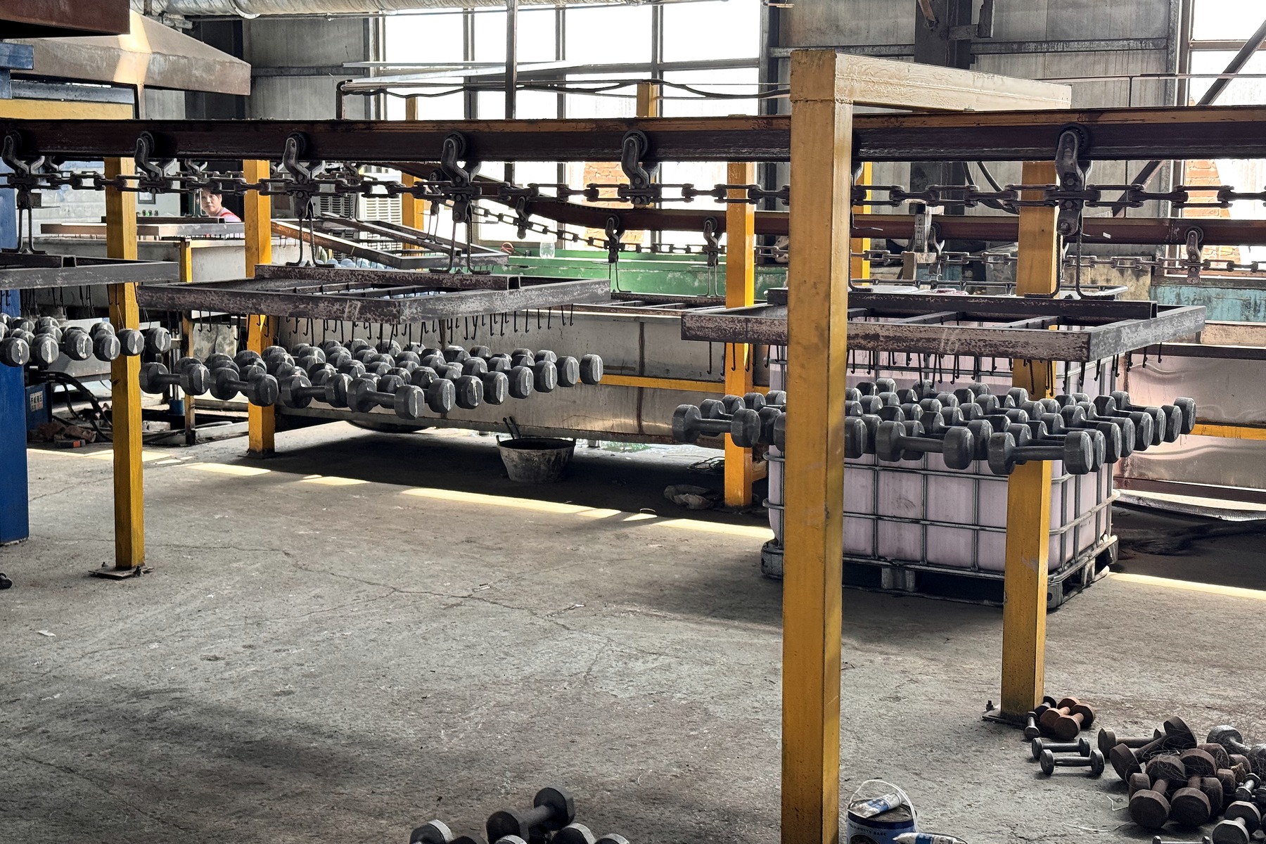 Dumbbell components moving through a regional production line