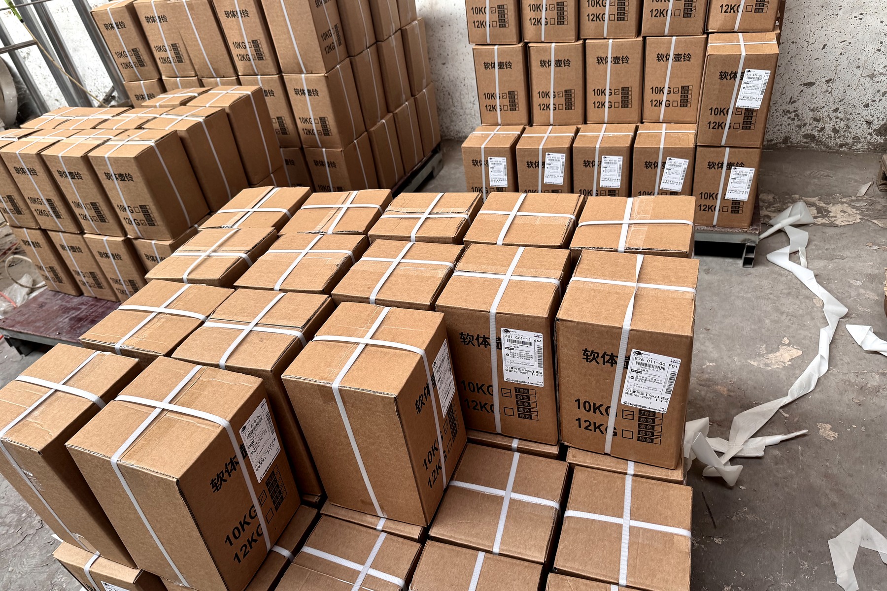 Cartons of PVC soft kettlebells prepared in documented weight and color batches